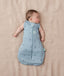 Newborn wearing an ergoPouch Cocoon Swaddle Bag 3.5 TOG Dragonflies with arms out