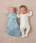 Two babies, one wearing a Cocoon Swaddle Bag 2.5 TOG Dragonflies and the other in a Layer