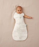 Newborn wearing an ergoPouch Cocoon Swaddle Bag 2.5 TOG Oatmeal Marle with one arm out
