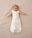 Newborn wearing an ergoPouch Cocoon Swaddle Bag 2.5 TOG Oatmeal Marle with arms out