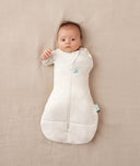 Newborn wearing an ergoPouch Cocoon Swaddle Bag 3.5 TOG Oatmeal Marle with one arm out