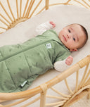 Newborn wearing an ergoPouch Cocoon Swaddle Bag 3.5 TOG Willow with arms out
