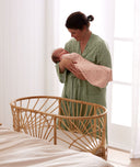 Mum wearing a a Matchy Matchy Robe, holding newborn wearing an ergoPouch Cocoon Swaddle Bag 1.0 TOG Daisies