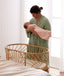 Mum wearing a a Matchy Matchy Robe, holding newborn wearing an ergoPouch Cocoon Swaddle Bag 1.0 TOG Daisies