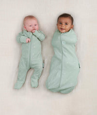 Two babies, one wearing a Cocoon Swaddle Bag 0.2 TOG Sage and the other in a Layer