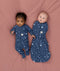 Two babies wearing Starbeam sleepwear, one in Long Sleeve layer 1.0 TOG and the other in Cocoon Swaddle Bag 1.0 TOG