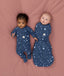 Two babies wearing Starbeam sleepwear, one in Long Sleeve layer 1.0 TOG and the other in Cocoon Swaddle Bag 1.0 TOG