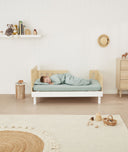 Toddler sleeping on bed made with ergoPouch Organic Fitted Sheet Sage