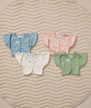 Flat lay of ergoPouch butterfly cardi in various colors, ideal for pairing with a cocoon swaddle.