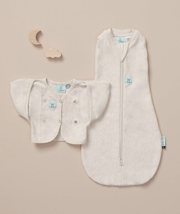 Flat lay of an ergoPouch cocoon swaddle and butterfly cardi, perfect for your newborn baby.