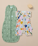 Flatlay of Cocoon Swaddle Bag 1.0 TOG Sweet Orchard and a Short Sleeve  Layer Fruit Salad