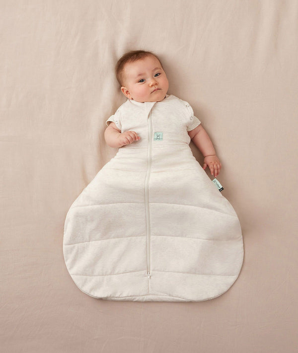 Newborn wearing an ergoPouch Hip Harness Cocoon Swaddle Bag 3.5 TOG Oatmeal Marle with arms out