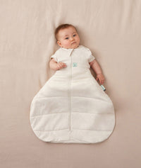 Newborn wearing an ergoPouch Hip Harness Cocoon Swaddle Bag 2.5 TOG Oatmeal Marle with arms out