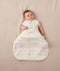 Newborn wearing an ergoPouch Hip Harness Cocoon Swaddle Bag 2.5 TOG Oatmeal Marle with arms out