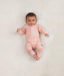 Newborn baby wearing an ergoPouch Long Sleeve Layer 0.2 TOG Berries