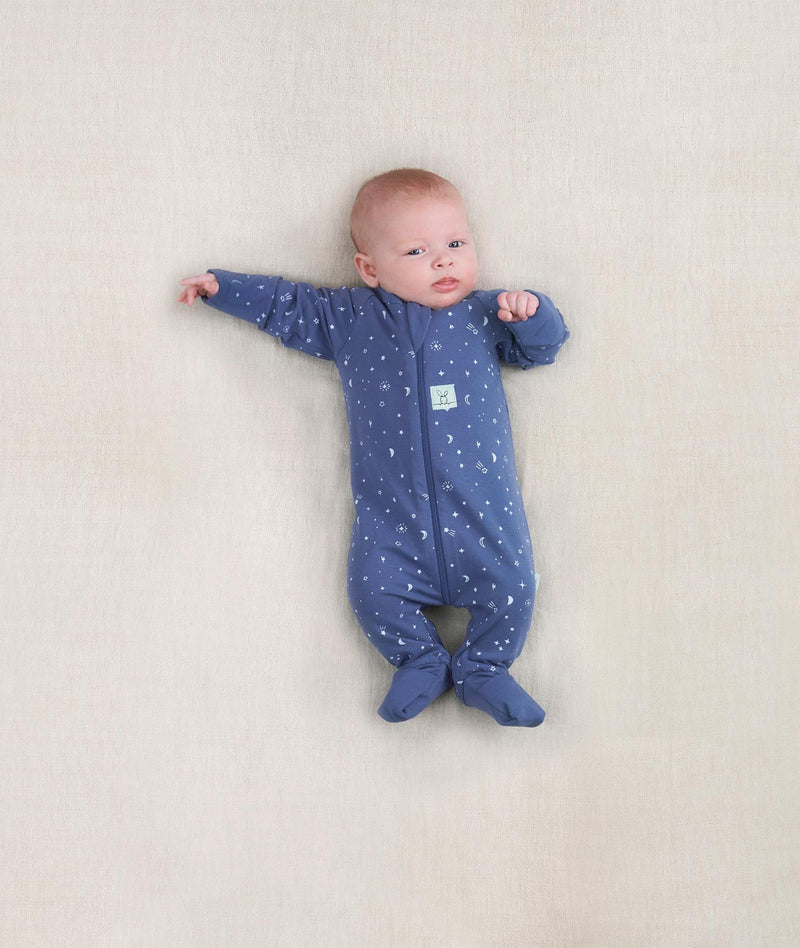 Newborn baby wearing an ergoPouch Long Sleeve Layer 0.2 TOG Night Sky