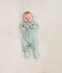 Newborn baby wearing an ergoPouch Long Sleeve Layer 0.2 TOG Sage
