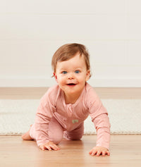 Baby wearing a lightweight ergoPouch Long Sleeve Layer 0.2 TOG Berries