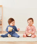 Baby wearing a lightweight ergoPouch Long Sleeve Layer 0.2 TOG Night Sky