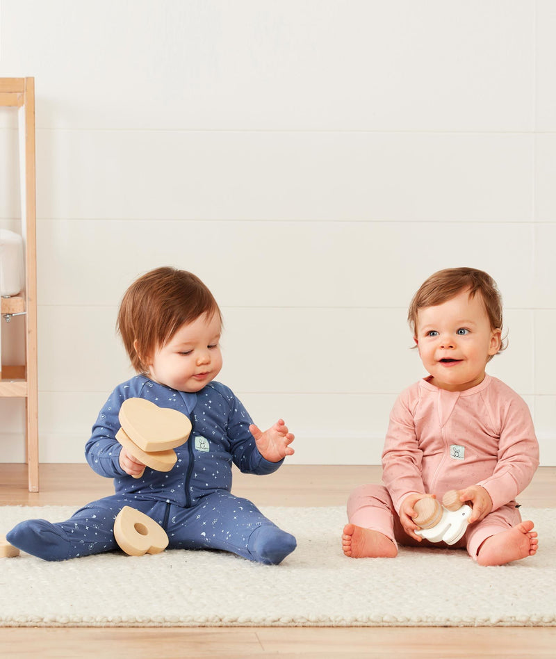 Baby wearing a lightweight ergoPouch Long Sleeve Layer 0.2 TOG Night Sky