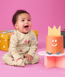 Baby wearing an ergoPouch Long Sleeve Layer 1.0 TOG Birthday Blobs