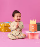 Baby wearing an ergoPouch Long Sleeve Layer 1.0 TOG Birthday Blobs