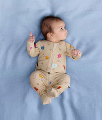 Newborn baby wearing an ergoPouch Long Sleeve Layer 1.0 TOG Birthday Blobs