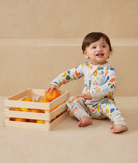 Baby wearing an ergoPouch Long Sleeve Layer 1.0 TOG Fruit Salad