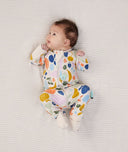 Newborn baby wearing an ergoPouch Long Sleeve Layer 1.0 TOG Fruit Salad