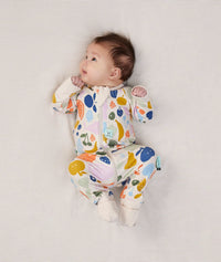 Newborn baby wearing an ergoPouch Long Sleeve Layer 1.0 TOG Fruit Salad