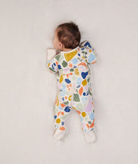 Newborn baby wearing an ergoPouch Long Sleeve Layer 1.0 TOG Fruit Salad