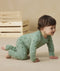 Baby wearing an ergoPouch Long Sleeve Layer 1.0 TOG Sweet Orchard