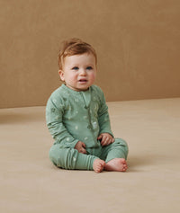 Newborn sitting, wearing an ergoPouch Long Sleeve Layer 1.0 TOG Sweet Orchard