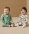Baby wearing an ergoPouch Long Sleeve Layer 1.0 TOG Fruit Salad