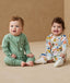 Baby wearing an ergoPouch Long Sleeve Layer 1.0 TOG Fruit Salad