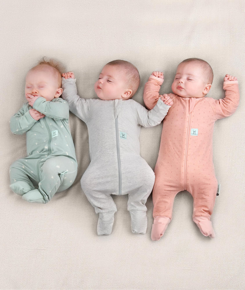 Newborn baby wearing an ergoPouch Long Sleeve Layer 0.2 TOG Sage