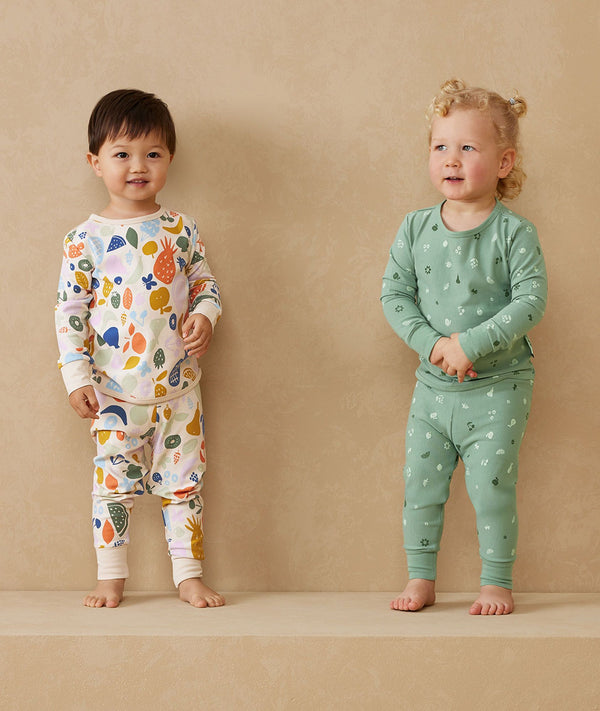 Toddler wearing 2-piece ergoPouch Long Sleeve Pyjamas 1.0 TOG Sweet Orchard
