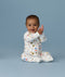 Happy infant sitting in an ergoPouch Long Sleeve Layer 1.0 TOG Daydream