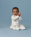 Happy infant sitting in an ergoPouch Long Sleeve Layer 1.0 TOG Daydream