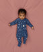Baby lying in an ergoPouch Long Sleeve Layer 1.0 TOG Daydream with the fold-over cuffs