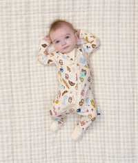 Baby lying on its back wearing ergoPouch Long Sleeve Layer 1.0 TOG in Bon Appetit
