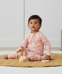 Toddler wearing an ergoPouch Long Sleeve Layer 1.0 TOG Daisies