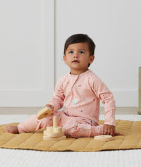 Toddler wearing an ergoPouch Long Sleeve Layer 1.0 TOG Daisies