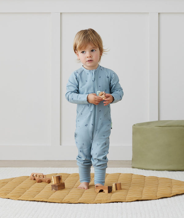 Toddler wearing an ergoPouch Long Sleeve Layer 1.0 TOG Dragonflies