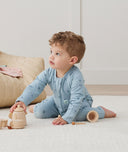 Toddler wearing an ergoPouch Long Sleeve Layer 1.0 TOG Dragonflies