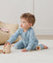 Toddler wearing an ergoPouch Long Sleeve Layer 1.0 TOG Dragonflies