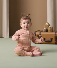 Infant sitting cozy in ergoPouch Long Sleeve Layer 1.0 TOG Elephant Parade