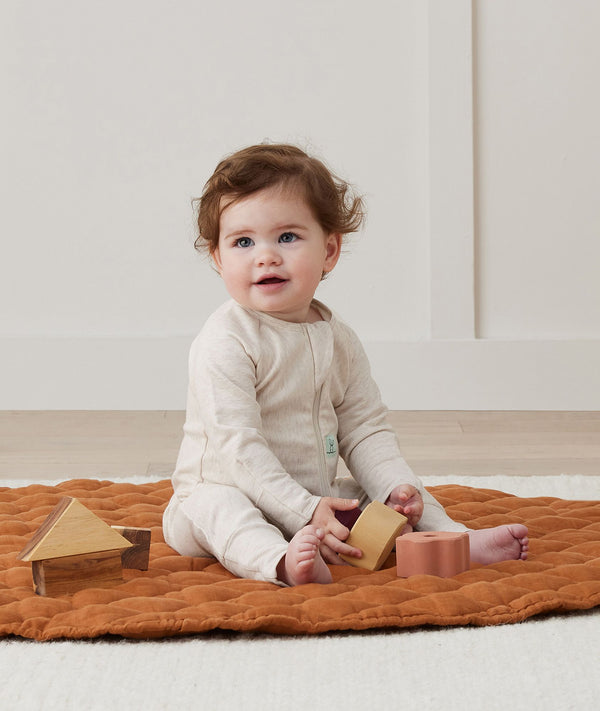 Baby wearing an ergoPouch Long Sleeve Layer 1.0 TOG Oatmeal Marle