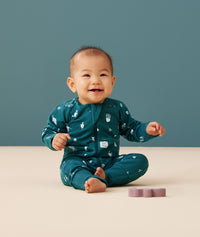 Baby wearing a lightweight ergoPouch Long Sleeve Layer 0.2 TOG Ocean Blue