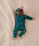 Baby wearing a lightweight ergoPouch Long Sleeve Layer 0.2 TOG Ocean Blue, having tummy time